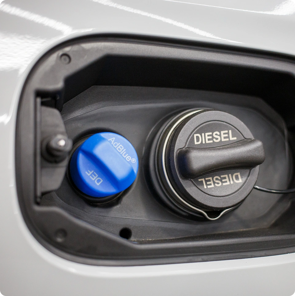 Close-up of AdBlue and Diesel filler caps on a diesel vehicle